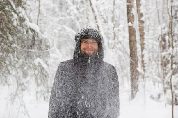 istock Man in fur winter hat with ear flaps smiling portrait 931934630