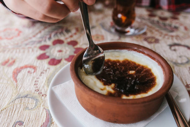 istock A girl in a cafe with a spoon has a baked rice dessert. 931936174