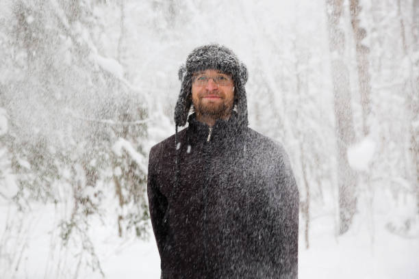 istock Man in fur winter hat with ear flaps smiling portrait 931936924
