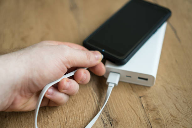 istock Man charging smartphone with power bank. 931938442