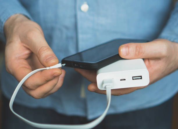 istock Man charging smartphone with power bank. 931938472