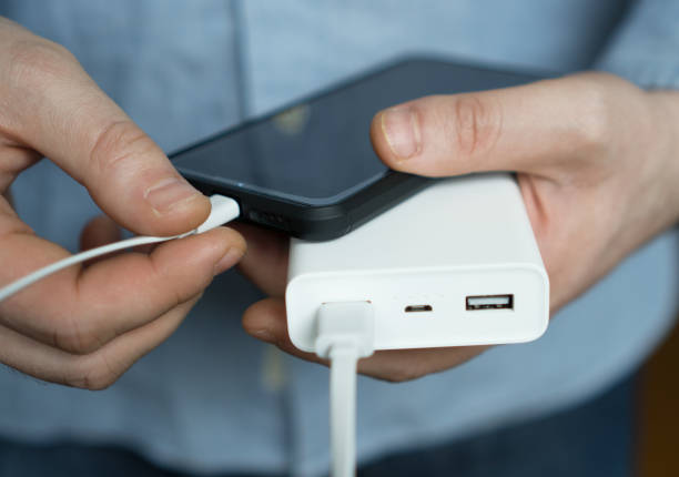 istock Man charging smartphone with power bank. 931938474