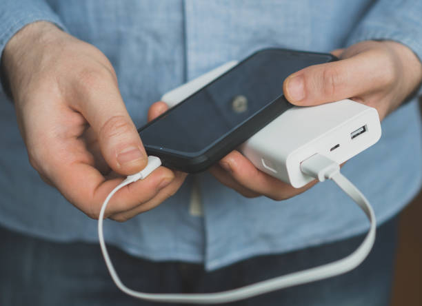 istock Man charging smartphone with power bank. 931938480
