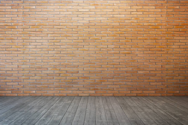 istock empty room with brick wall and wood floor 931938772