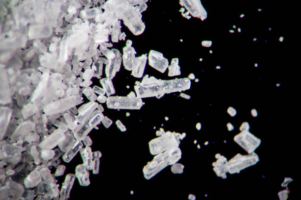 istock Creatine crystals by microscope. Athletic dietary supplement in details supermacro close-up. White cristales on black background or low key 931944852
