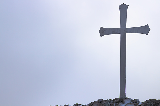 Metal Cross on a Hilltop at Winter