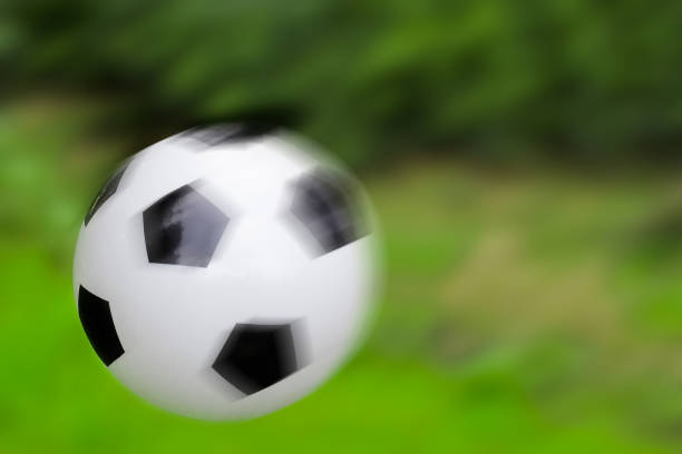 istock Soccer ball on a green background, soft focus 931947846