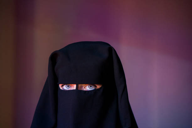 istock Arab woman with face covered with black niqab 931948138
