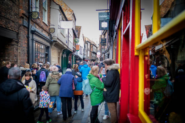 The Shambles, York 16th February 2018. Crowd congestion in The Shambles medieval and historic shopping street in the traditional city of York in Yorkshire England United Kingdom The Shambles, York 16th February 2018. Crowd congestion in The Shambles medieval and historic shopping street in the traditional city of York in Yorkshire England United Kingdom york yorkshire stock pictures, royalty-free photos & images