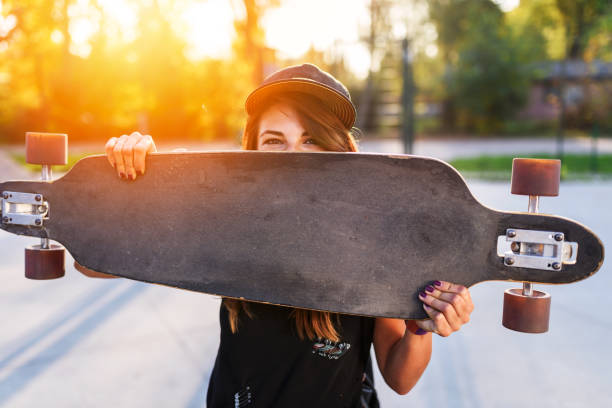 istock Cute urban girl holding skateboard in skatepark 931957708