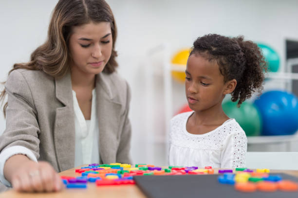 istock Ethnic elementary-age girl works with an occupational therapist 931961018