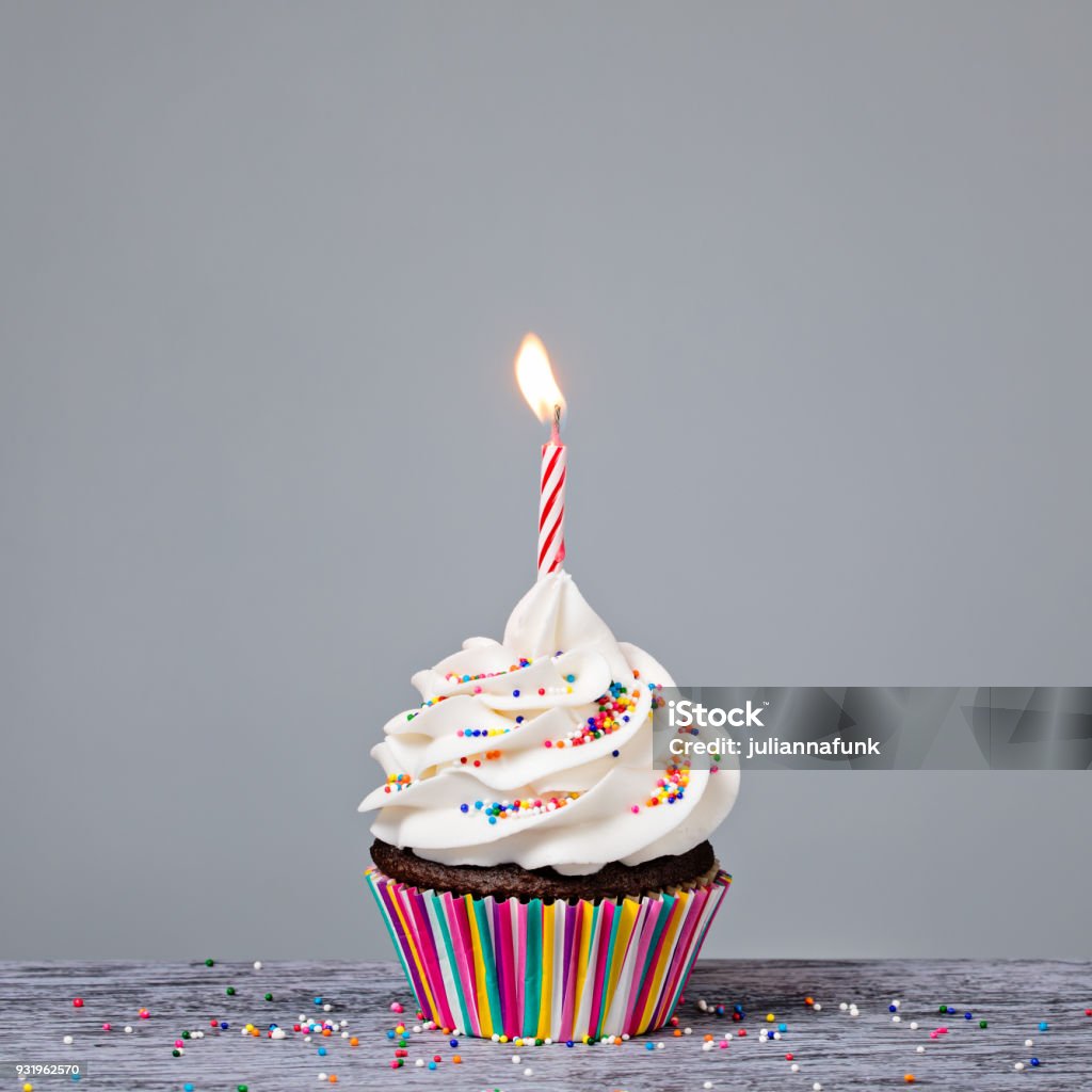 Birthday Cupcake with red candle Birthday Cupcake with a red candle and colorful sprinkles Birthday Stock Photo