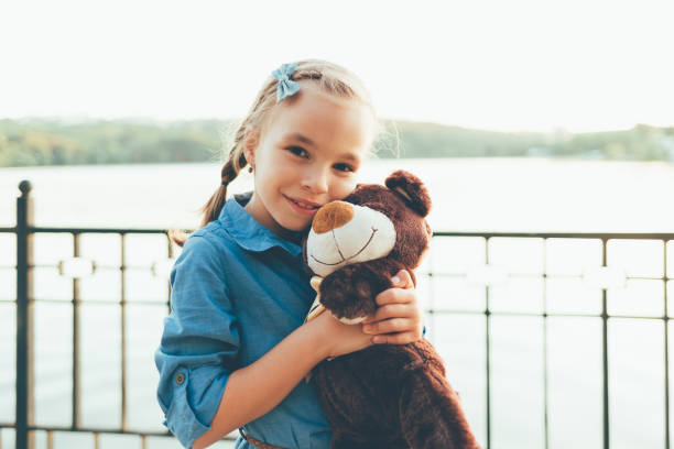 istock Girl embracing a cute teddy bear 931966168