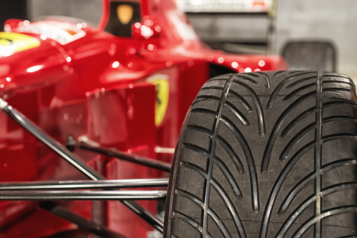 Romanshorn, Switzerland - June 4, 2017: Close up of a rain tire at a Ferrari formula 1 racing car. The picture was taken at a public exhibition in Romanshorn, Switzerland and shows the Ferrari jean alesi drove in the nineties. Ferrari is an Italian sports car manufacturer based in Maranello, Italy. Since it’s beginnings, Ferrari has been involved in motorsport.