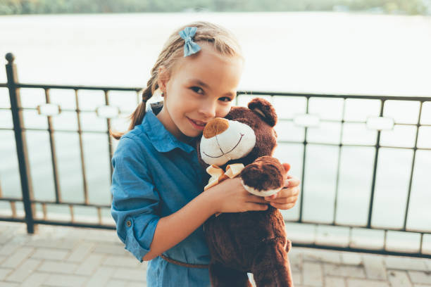 istock Girl embracing a cute teddy bear 931968202