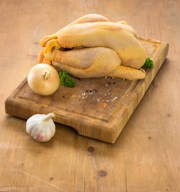 istock Raw chicken ready to be cooked on wooden cutting board 931975204