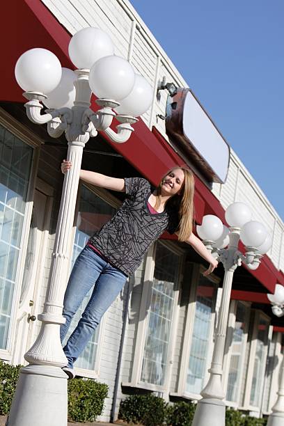 istock Girl Swinging on Lamppost 93198437