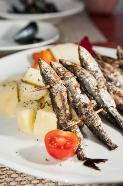 istock Grilled sardines with seasoned cooked potatoes and fresh tomatoes 931989830
