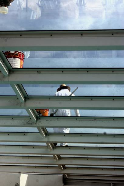 istock Low Angle View Of Worker Walking On Glass Ceiling 931993102