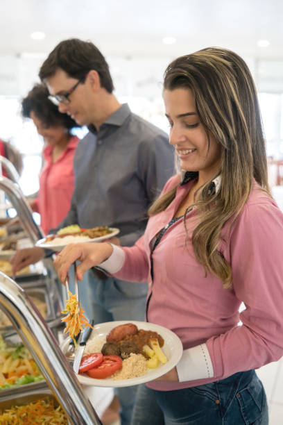 istock Group of people serving food at a buffet 931993982