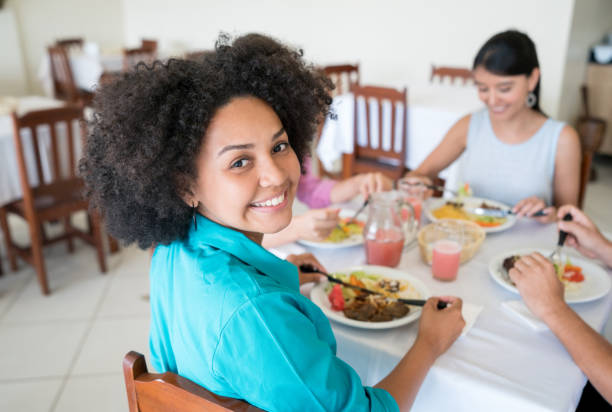 istock Happy African American woman eating at a restaurant 931994122