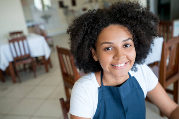 istock Portrait of a happy waitress working at a restaurant 931994152