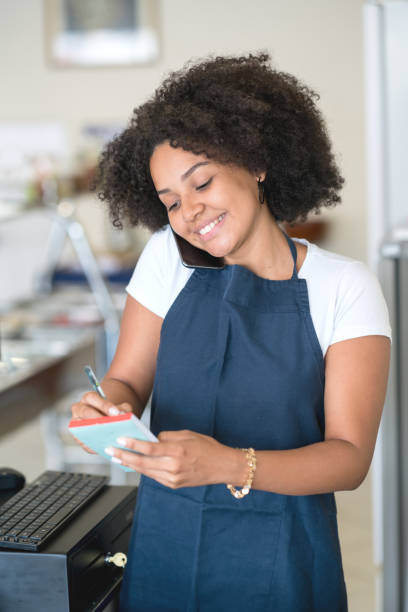 istock Waitress talking on the phone at a restaurant 931994256