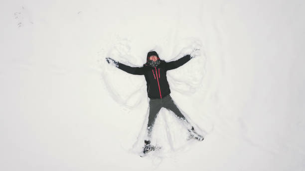 istock High Angle View Of Man Lying Down On Snow 932002348