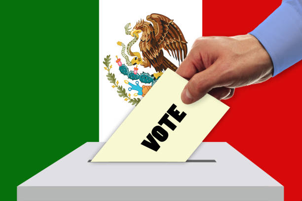 istock Man voting on elections in Mexico front of flag 932003354