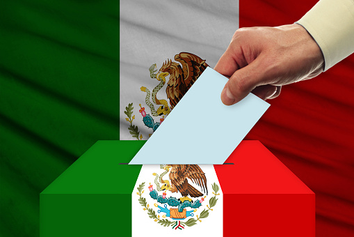 Man voting on elections in Mexico front of flag