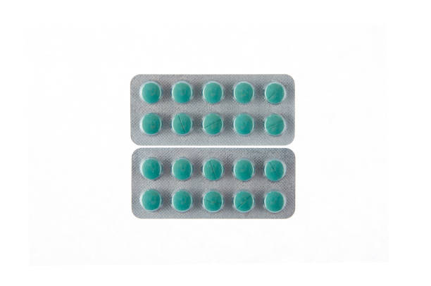 istock two plates of green pills on white isolated background 932008738