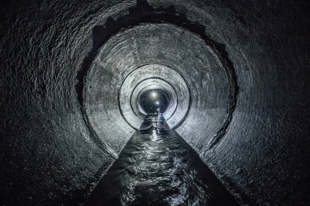 istock Diggers are exploring underground river flowing in round sewer tunnel 932013958