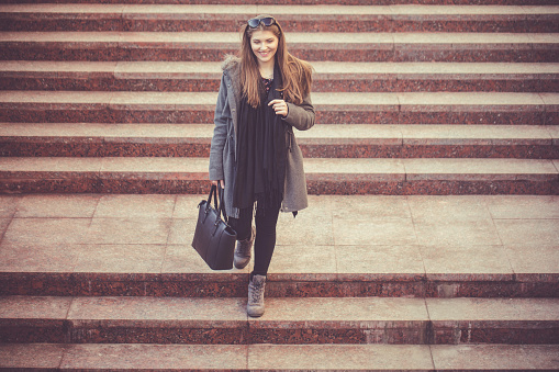 Cute young woman on the stairs