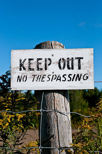 istock Keep Out No Trespassing Sign on Post with Blue Sky 93202101