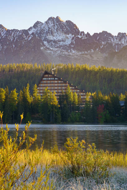 Mountain lake Strbske pleso in National Park High Tatra, Slovakia, Europe. Sunrise, early morning sunlight. Ski resort in spring and autumn time. Peaceful nature wallpaper. Tranquil vacations travel concept. Mountain lake Strbske pleso in National Park High Tatra, Slovakia, Europe. Sunrise, early morning sunlight. Ski resort in spring and autumn time. Peaceful nature wallpaper. Tranquil vacations travel concept. pleso stock pictures, royalty-free photos & images