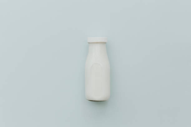 istock Top view of milk bottle on pastel background. Minimal creative concept 932022148