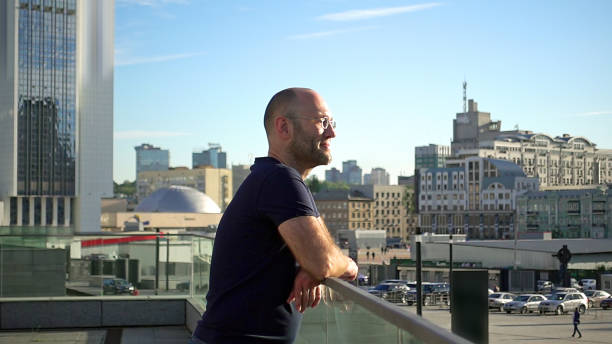 istock Handsome man is standing on the urban balcony 932026998