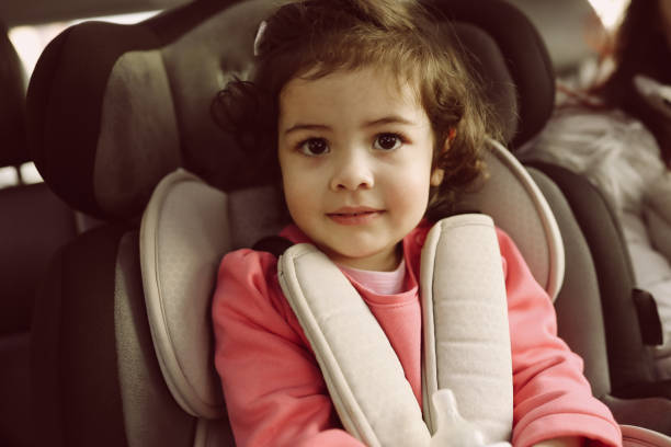 istock Mother and little daughter on back seat in car 932027082