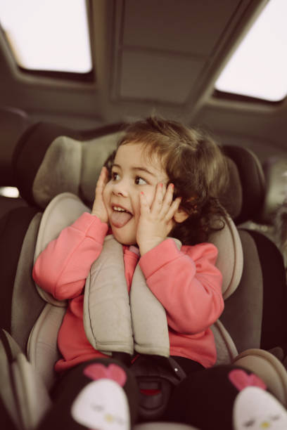 istock Little girl on back seat in car 932030050