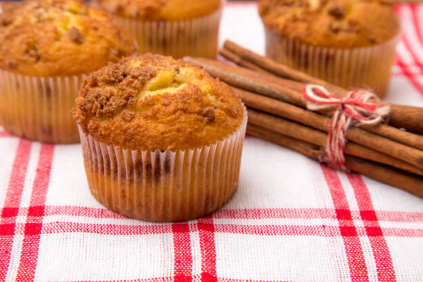 Homemade lemon muffins with ginger in ceramic baking pans close-up, selective focus.