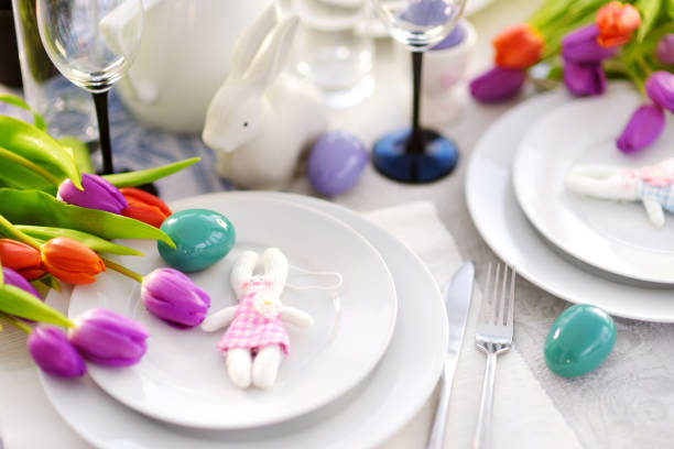 istock Beautiful table setting with crockery and flowers for Easter celebration 932033042