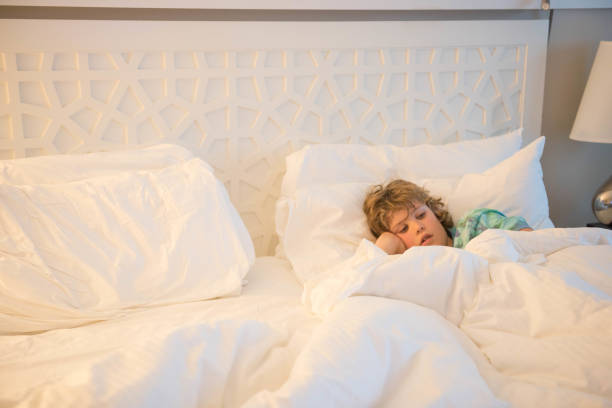 istock Child in a hotel room sick while on vacation 932038190