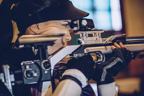 istock Young woman aiming a air rifle 932043320