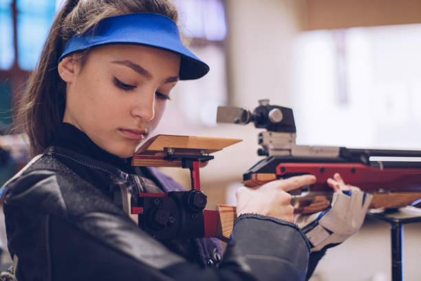 istock Beautiful woman with a machine gun. 932044014