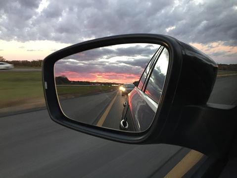 Sunset from mirror while driving