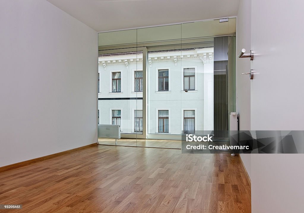 modern living new modern living room, the view through the French window shows the front of an old residential building opposite Apartment Stock Photo
