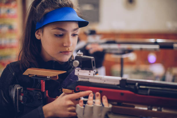 istock Beautiful woman aiming a air rifle 932054948
