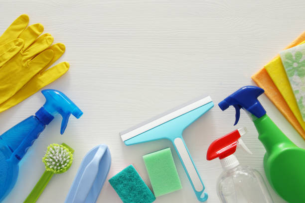 istock Spring cleaning concept with supplies on wooden table. 932055220