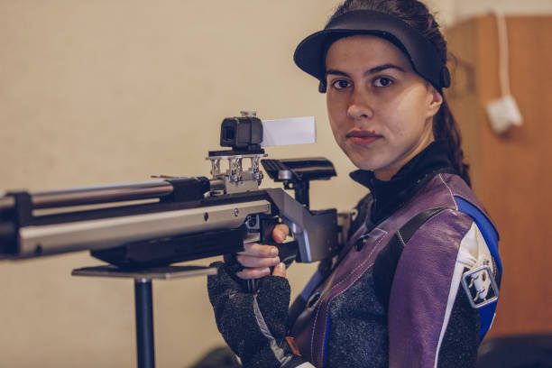 istock Beautiful young woman at shooting range 932058616