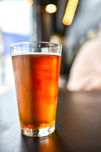 Craft Beer in Pint Glass and Bokeh Background